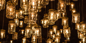 A bunch of lightbulbs hanging from a dark ceiling.