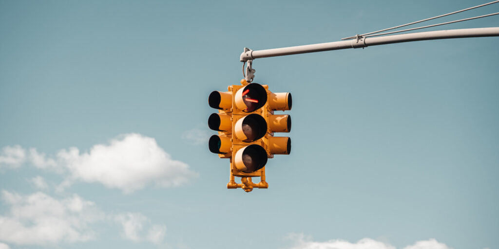 Traffic light with clouds in the background