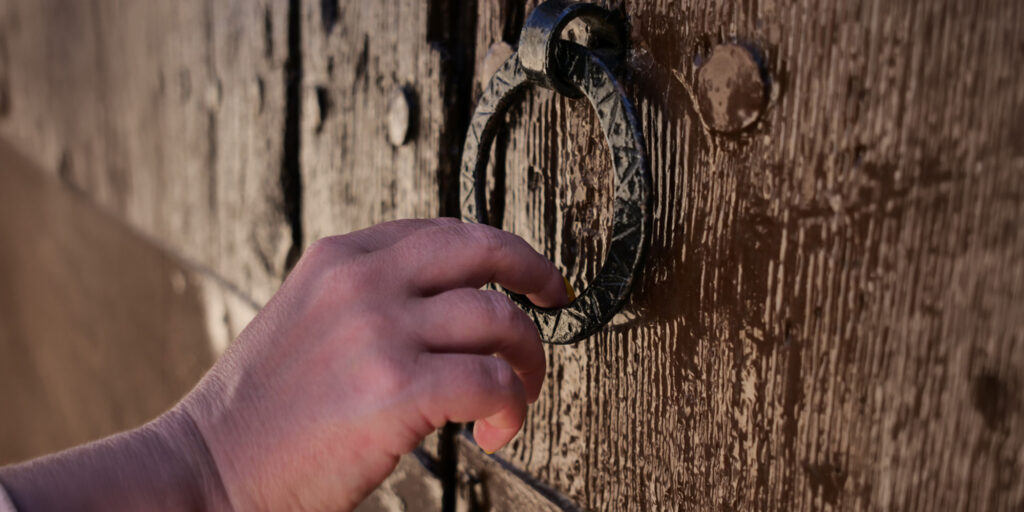 Hand knocking on the door