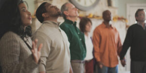 People holding hands and praying