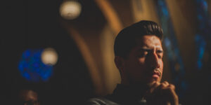 Close up of man praying in church